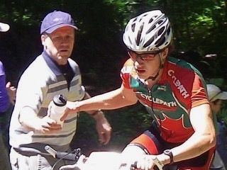 Michael racing mountain bikes as a junior, taking a bottle in the feed zone